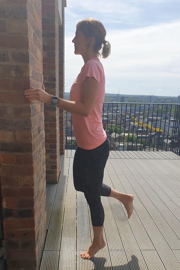 دونده در حال انجام حرکت بلندکردن ساق یک-پا